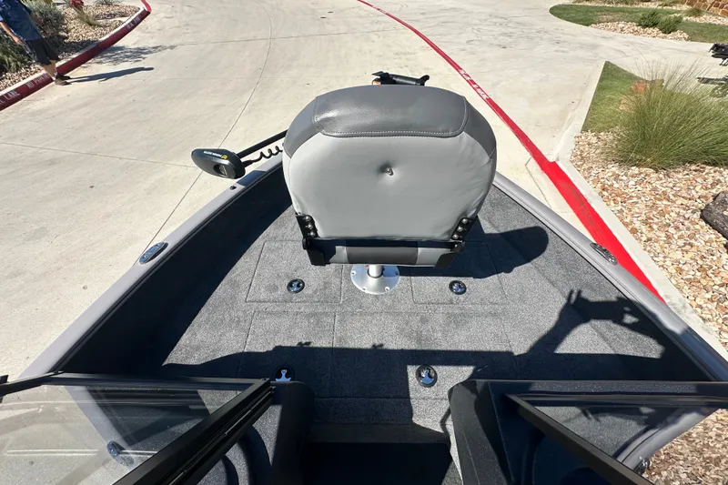 Slide: The Image of 2027 Tracker Pro Guide V-16 WT boat interior with gray seating and carpeted deck. - 19