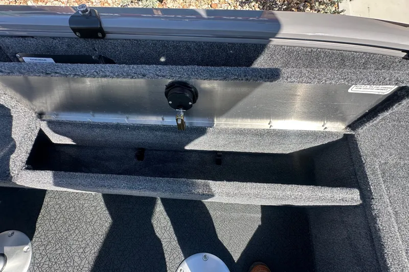 Slide: The Image of 2027 Tracker Pro Guide V-16 WT boat interior storage compartment with carpeted finish. - 24