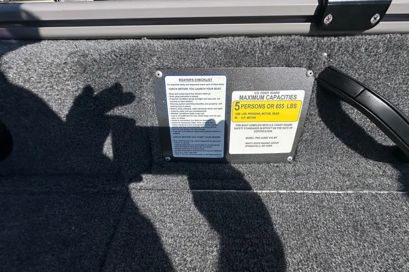 Slide: The Image of 2027 Tracker Pro Guide V-16 WT boat capacity plate, showing maximum capacity of 5 persons or 655 lbs. - 21