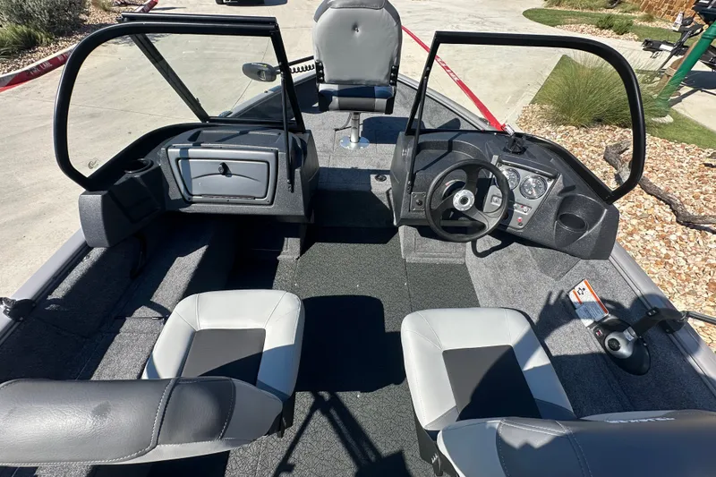 Slide: The Image of 2027 Tracker Pro Guide V-16 WT boat interior with steering wheel and seating. - 22