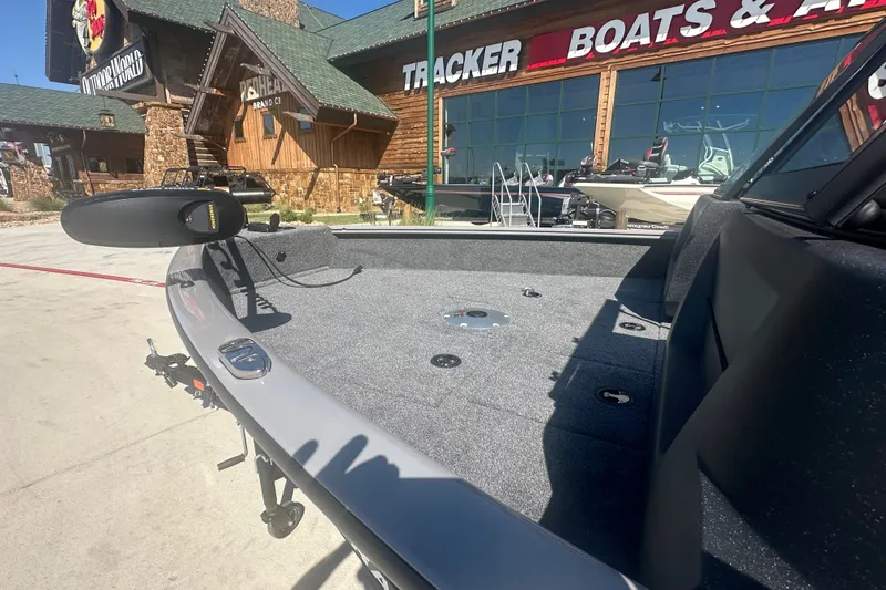 Slide: The Image of 2027 Tracker Pro Guide V-16 WT boat displayed outside Tracker Boats & ATVs store. - 14