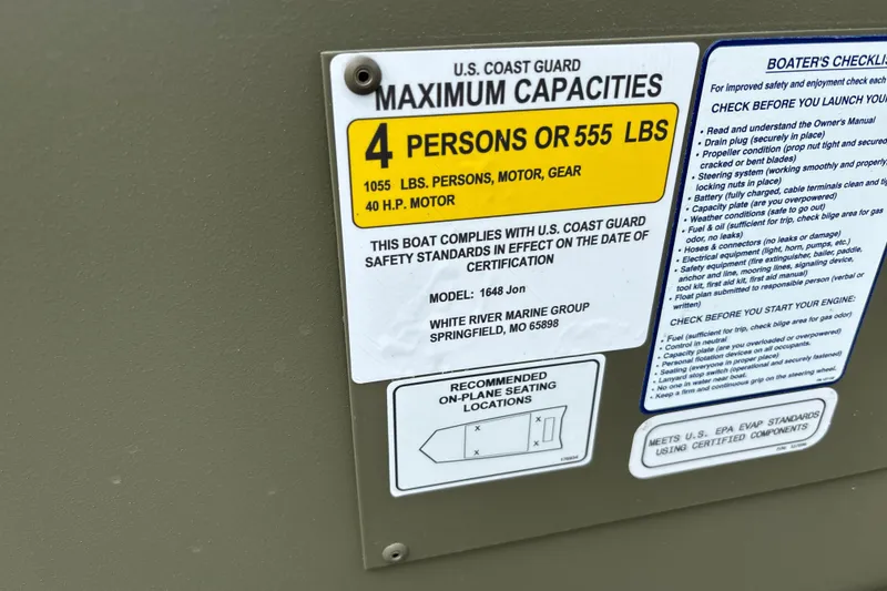 Slide: The Image of 2027 Tracker Grizzly 1648 Utility boat capacity label, U.S. Coast Guard compliance details. - 15