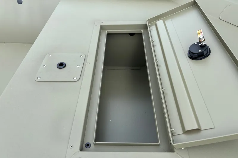 Slide: The Image of Open storage compartment on 2027 Tracker Grizzly 1648 Utility boat, showcasing interior space. - 14