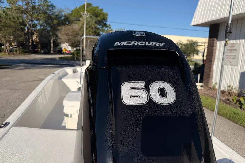 Slide: The Image of 2027 Mako Pro Skiff 15 CC with Mercury 60 engine, parked outdoors. - 10