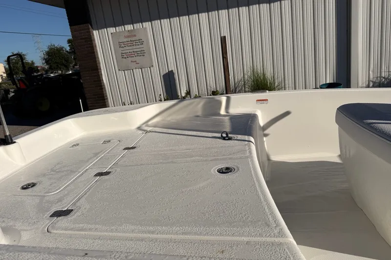 Slide: The Image of 2027 Mako Pro Skiff 15 CC boat interior with storage compartments and seating. - 9
