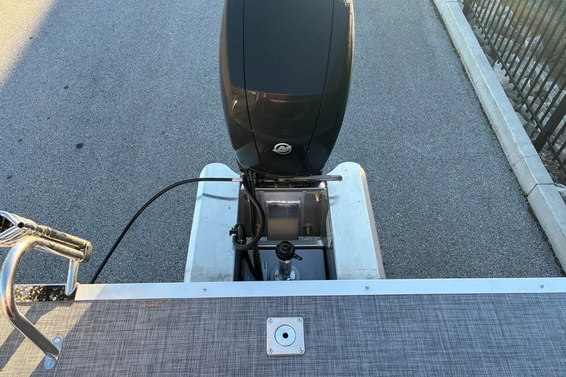 Slide: The Image of Rear view of 2026 Sun Tracker SportFish 22 DLX boat with outboard motor. - 13