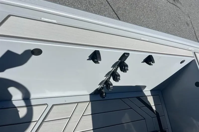 Slide: The Image of 2027 Tracker Bass Tracker Classic CC boat interior with rod holders and storage area. - 16