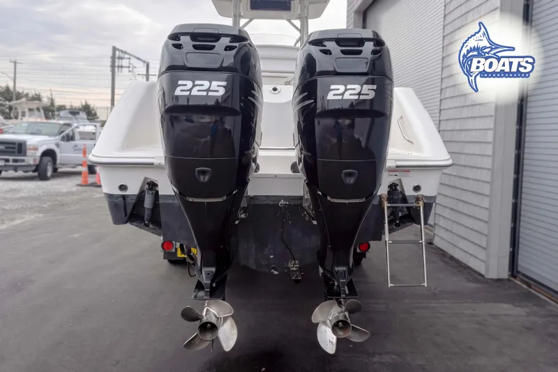 Slide: The Image of Twin 225 horsepower engines on a 2006 Boston Whaler 270 Outrage boat, rear view. - 12