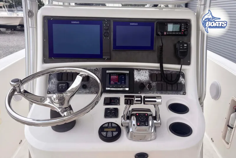 Slide: The Image of 2006 Boston Whaler 270 Outrage helm with dual Simrad displays and marine controls. - 6