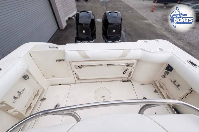 Slide: The Image of 2006 Boston Whaler 270 Outrage boat interior with dual engines and storage compartments. - 9