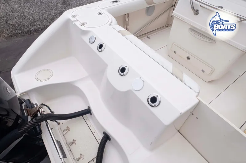 Slide: The Image of 2006 Boston Whaler 270 Outrage boat interior with seating and storage compartments. - 11