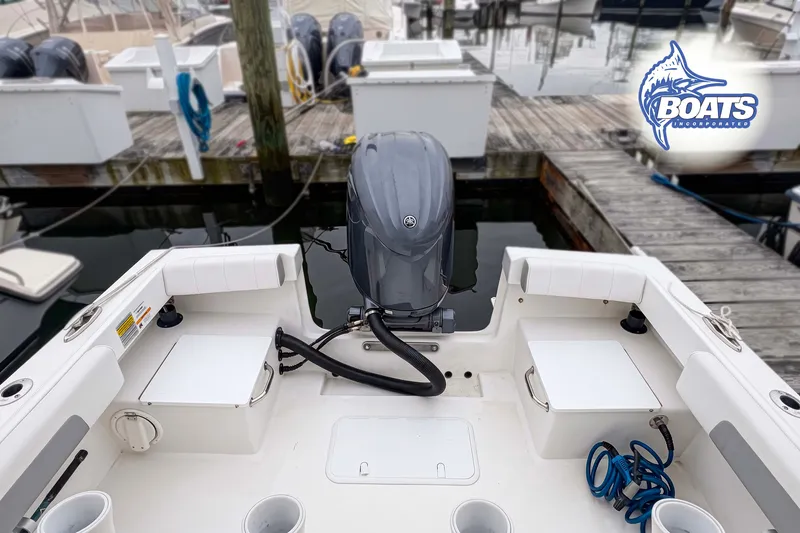 Slide: The Image of 2024 Parker 2300 Special Edition boat at dock with outboard motor and fishing gear. - 10
