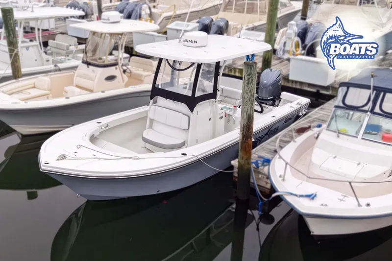 Slide: The Image of 2024 Parker 2300 Special Edition boat docked at marina with other vessels. - 1