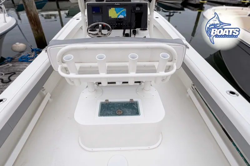 Slide: The Image of 2024 Parker 2300 Special Edition boat interior with helm, rod holders, and navigation system. - 9