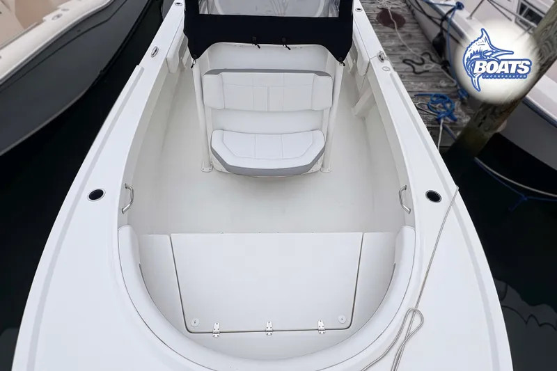 Slide: The Image of 2024 Parker 2300 Special Edition boat, white interior, docked at marina. - 4