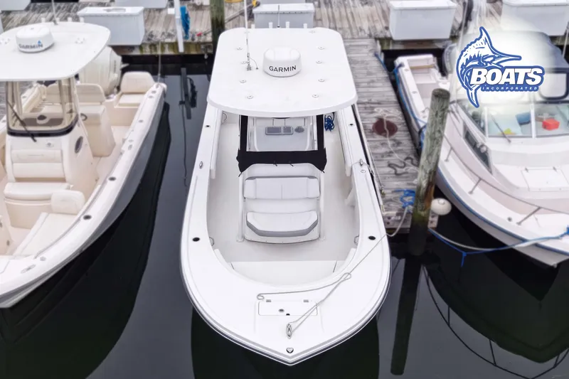 Slide: The Image of 2024 Parker 2300 Special Edition boat docked at marina, top view. - 2