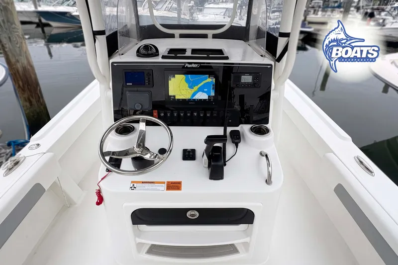 Slide: The Image of 2024 Parker 2300 Special Edition boat console with navigation equipment and steering wheel. - 8