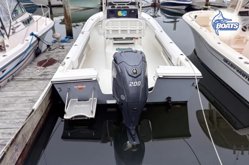 Slide: The Image of 2024 Parker 2300 Special Edition boat docked with Yamaha 200 engine. - 13