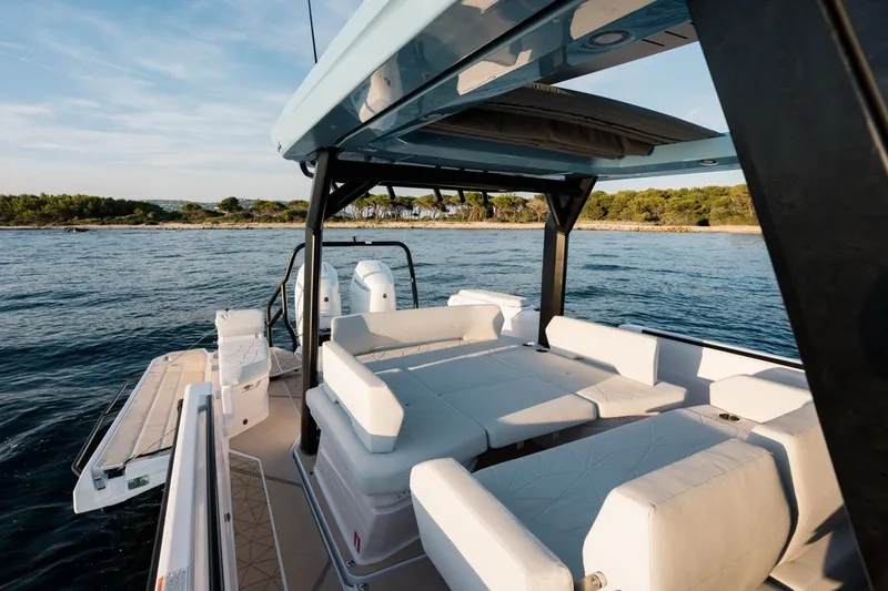 Slide: The Image of 2027 Axopar 38 Cross Top boat with spacious seating on calm waters. - 14