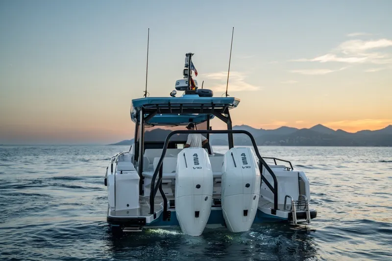Slide: The Image of Axopar 38 Cross Top 2027 boat cruising at sunset with dual engines. - 23
