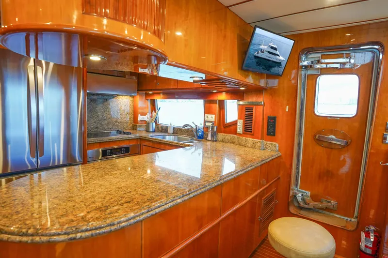 Slide: The Image of Luxurious Monte Fino 82MY 2001 yacht kitchen with granite countertops and stainless steel appliances. - 29