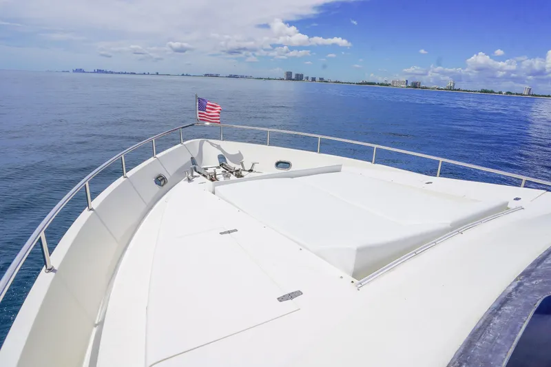 Slide: The Image of Monte Fino 82MY yacht bow with American flag, ocean view, clear sky, 2001 model. - 8