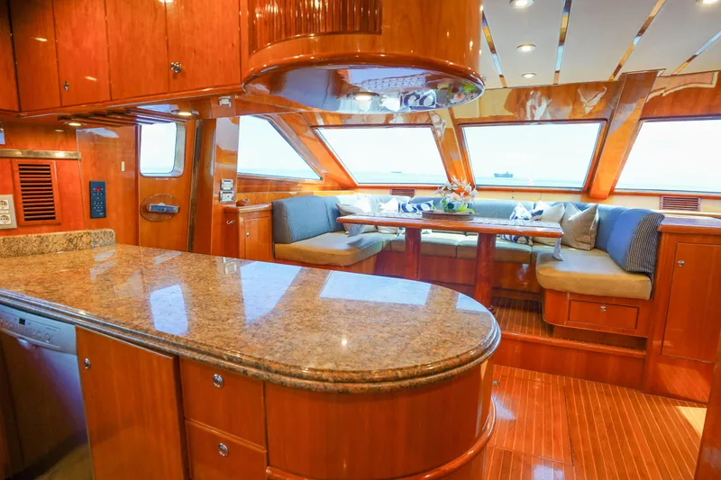 Slide: The Image of Luxurious interior of 2001 Monte Fino 82MY yacht with elegant wood finishes and spacious seating. - 28