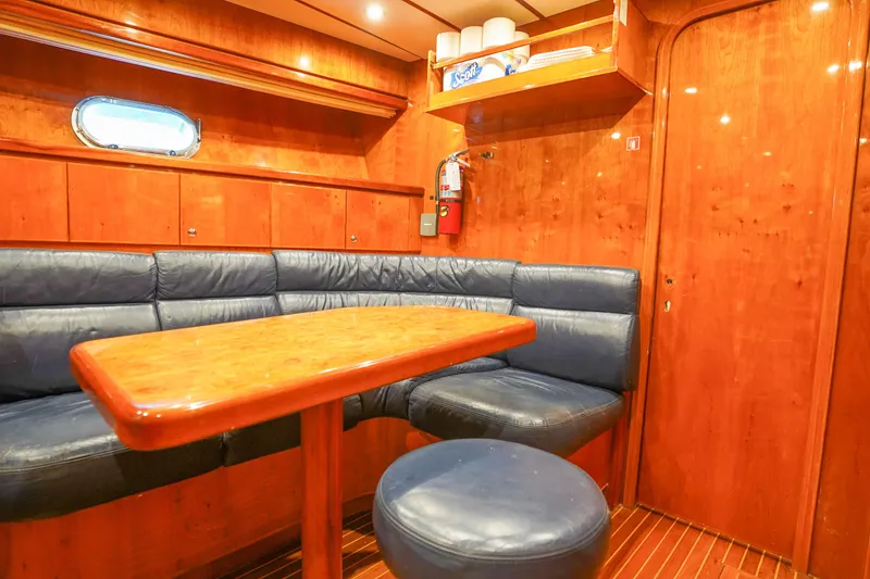 Slide: The Image of Luxurious Monte Fino 82MY 2001 yacht interior with wooden finish and blue leather seating. - 51