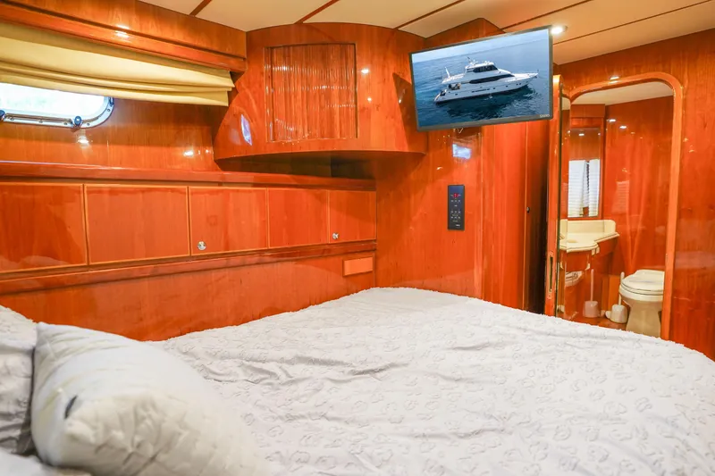 Slide: The Image of Luxurious Monte Fino 82MY 2001 yacht bedroom with wood paneling and ensuite bathroom. - 44