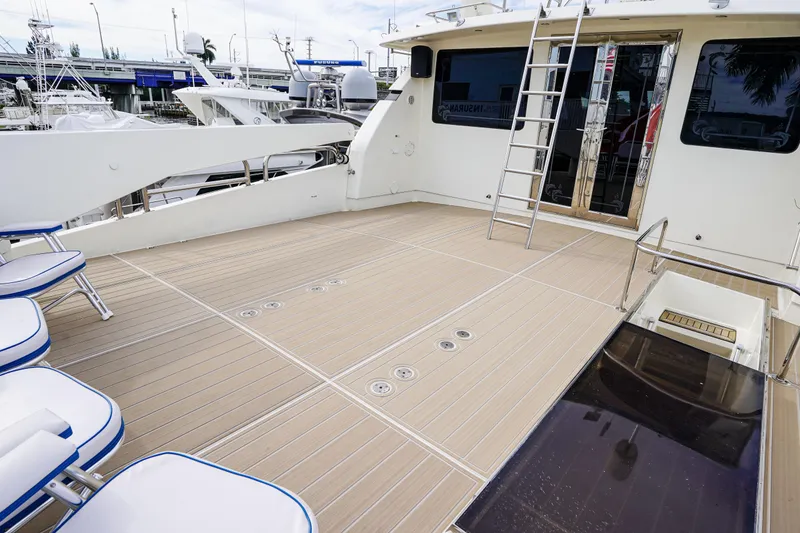 Slide: The Image of Spacious deck of 2001 Monte Fino 82MY yacht with seating and ladder. - 17