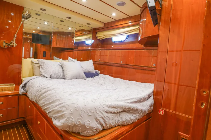 Slide: The Image of Luxurious bedroom interior of 2001 Monte Fino 82MY yacht with wood paneling and cozy bedding. - 43