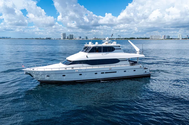 Slide: The Image of Luxury 2001 Monte Fino 82MY yacht cruising on calm ocean waters under a blue sky. - 1