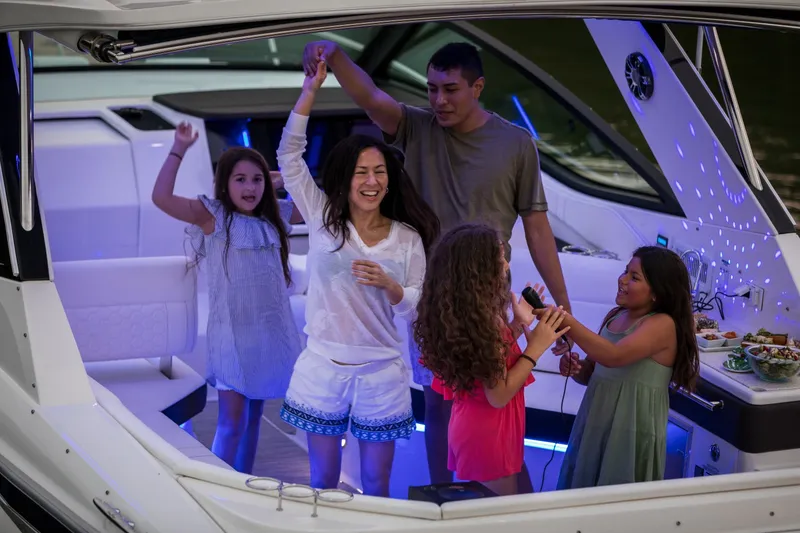 Slide: The Image of A family enjoys a party on a Sea Ray Sundancer 320 boat. - 41