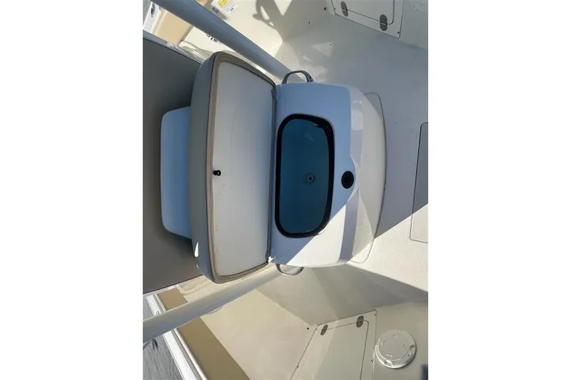 Slide: The Image of 2019 Stingray 236 CC boat interior with open storage compartment. - 13