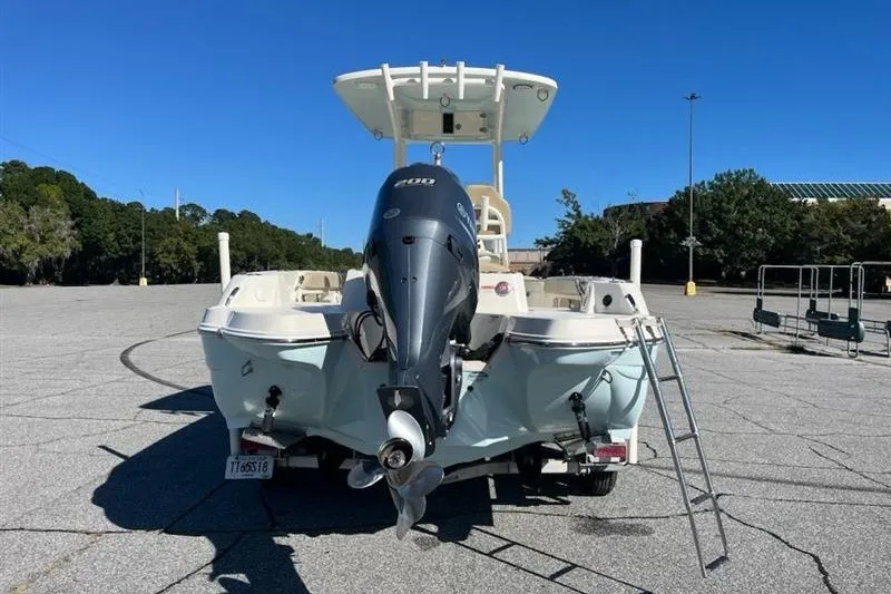 Slide: The Image of 2019 Stingray 236 CC boat with outboard motor in a parking lot. - 5