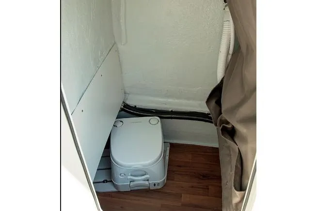 Slide: The Image of Manufacturer Provided Image: 2019 Stingray 236 CC boat interior with portable toilet. - 31
