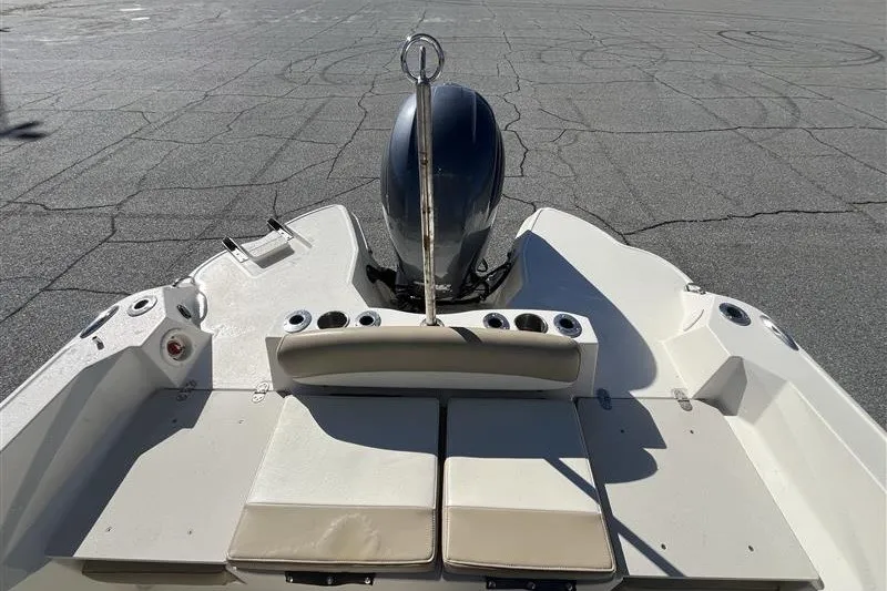 Slide: The Image of 2019 Stingray 236 CC boat with outboard motor, rear seating, and cup holders. - 17