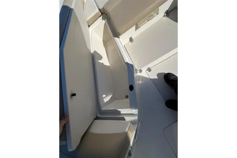 Slide: The Image of 2019 Stingray 236 CC boat interior storage compartment with open hatch. - 7