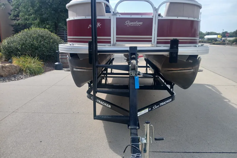 The Image of 2014 Sun Tracker Party Barge 18 on trailer, parked on concrete driveway. - 0