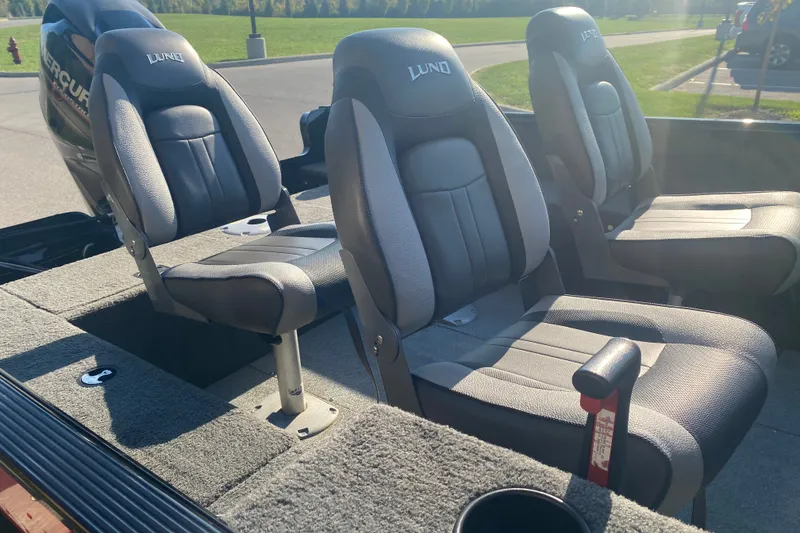 Slide: The Image of 2014 Lund 1650 Rebel XL SS boat interior with three cushioned seats. - 12