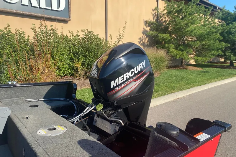 Slide: The Image of 2014 Lund 1650 Rebel XL SS boat with Mercury FourStroke engine, parked outdoors. - 6