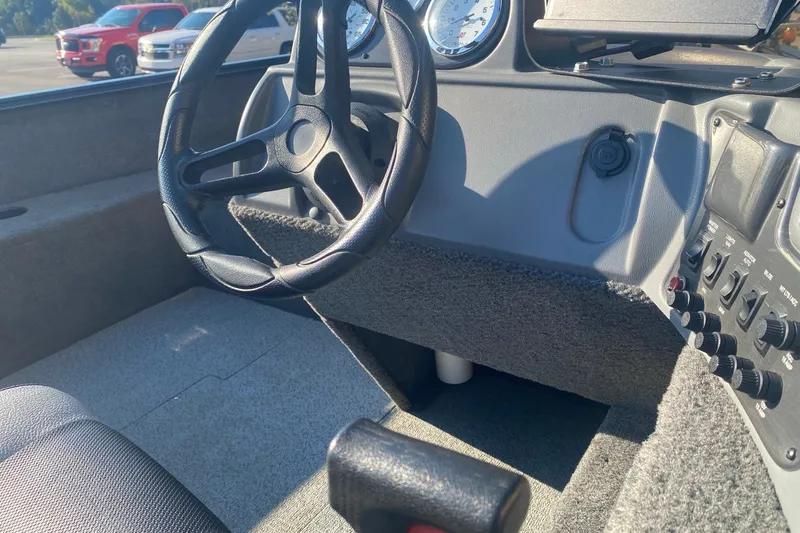 Slide: The Image of 2014 Lund 1650 Rebel XL SS boat interior with steering wheel and control panel. - 11