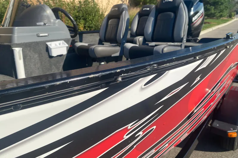 Slide: The Image of 2014 Lund 1650 Rebel XL SS boat with stylish red and black exterior design. - 5