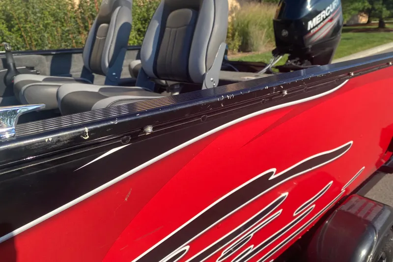 Slide: The Image of 2014 Lund 1650 Rebel XL SS boat with red exterior and Mercury motor. - 4