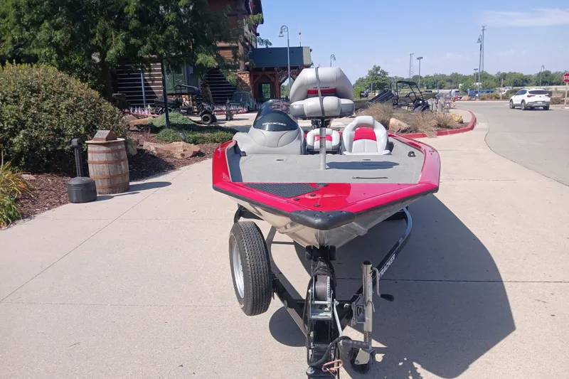 The Image of 2012 Tracker Pro Team 175 boat on trailer, parked outdoors in sunny setting. - 0