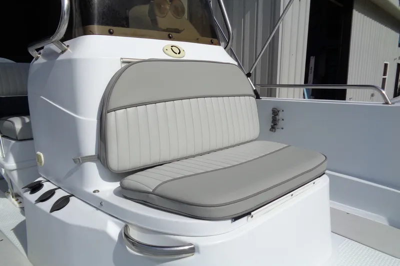 Slide: The Image of 2004 Triumph 190 Bay boat with gray cushioned seating and stainless steel railing. - 5