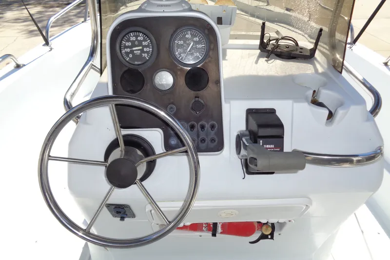 Slide: The Image of 2004 Triumph 190 Bay boat dashboard with steering wheel and Yamaha controls. - 11