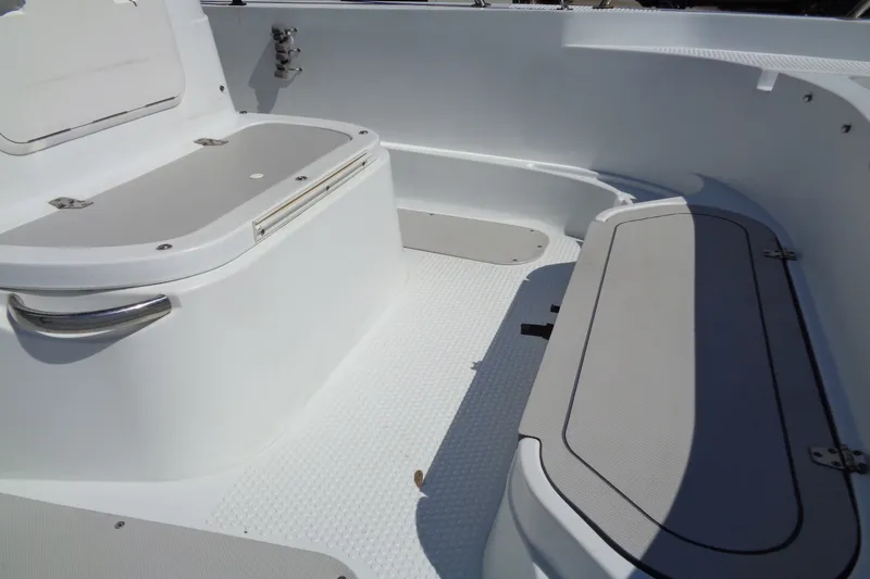 Slide: The Image of 2004 Triumph 190 Bay boat interior with storage compartments and seating. - 9