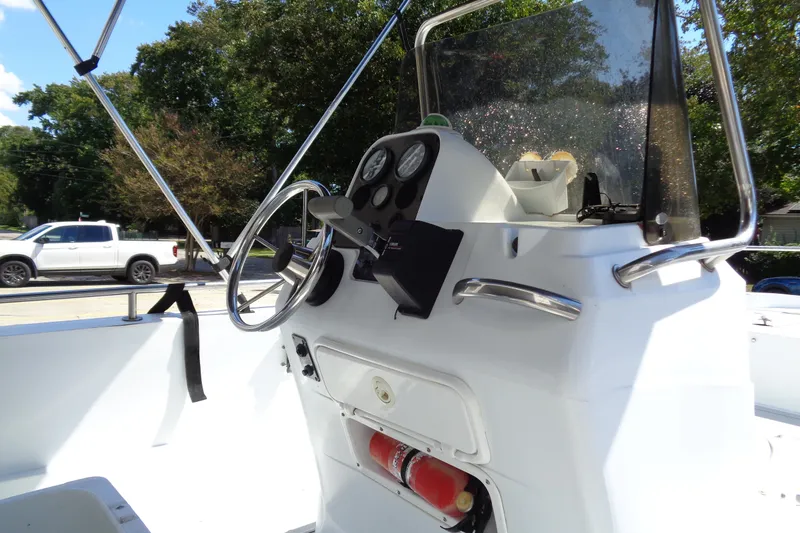 Slide: The Image of 2004 Triumph 190 Bay boat console with steering wheel and gauges. - 17
