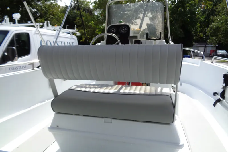 Slide: The Image of 2004 Triumph 190 Bay boat interior with cushioned seating and steering console. - 6